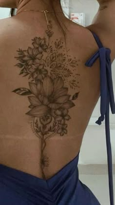 the back of a woman's body with flowers on it