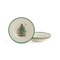 two white plates with green trim and a christmas tree on the front one is empty