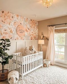 a baby's room decorated in pink and white