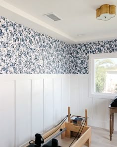 an empty room with blue and white wallpaper