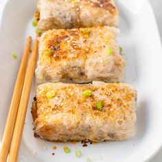 some food on a white plate with chopsticks