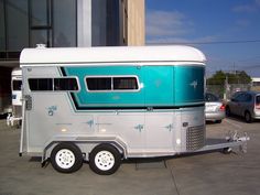 an old trailer is parked in a parking lot