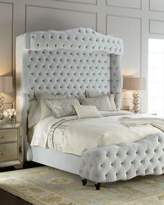 a white bed sitting in a bedroom on top of a rug