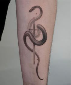 a snake and dagger tattoo on the leg