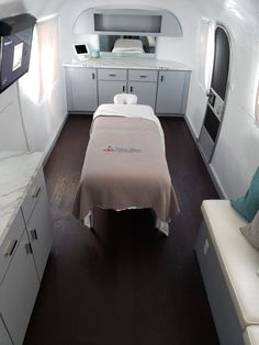 an airplane cabin with a bed and desk