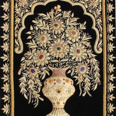 an ornate vase with flowers on a black background