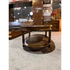 a coffee table sitting on top of a carpeted floor next to a dresser and mirror