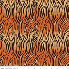 an orange and black tiger print pattern with wavy lines on it's surface is shown