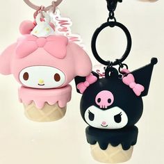 two key chains that are shaped like ice cream cones with hello kitty characters on them