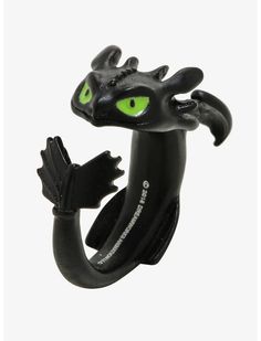 a black dragon ring with green eyes on it's head and tail, sitting in front of a white background