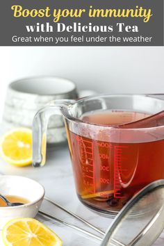 a pitcher filled with tea next to lemons and measuring cups