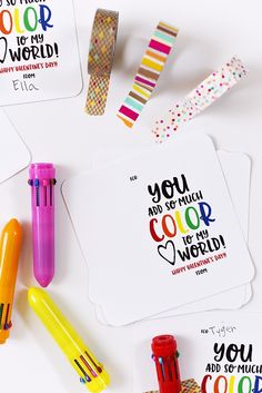 some colorful markers and stickers on top of a white surface with words that read, you are the color of the world