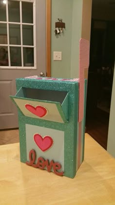 a cardboard box with the word love on it sitting on a table in front of a door