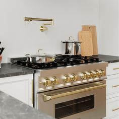 a stove top oven sitting inside of a kitchen next to a counter with pots and pans on it