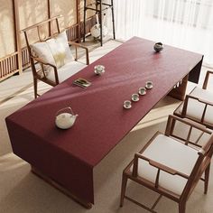 a long table with chairs around it in front of a window and other items on the floor