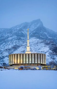 a large building with a tall tower in the middle of it's snowing field