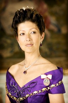 an older woman wearing a tiara and diamond necklace