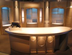 a curved counter in front of two windows with round lights on each side and circular lighting above it