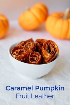 small white bowl filled with Caramel Pumpkin Fruit Leather roll ups. 3 mini pumpkins in background Leather Pumpkin, Dehydrating Food Storage, Dehydrating Food, Pumpkin Recipe, Food Dehydrator