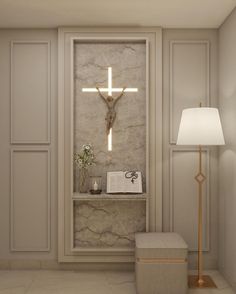 a white room with a cross on the wall and a lamp in front of it