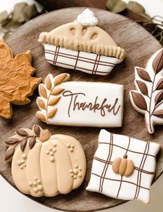 decorated cookies on a wooden platter with the words, thank you and pumpkins