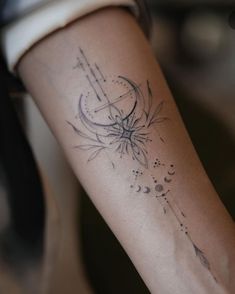 a woman's arm with a tattoo design on the left side of her arm