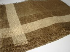 a brown and white checkered rug on top of a table