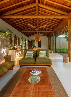 a living room filled with furniture and a wooden ceiling