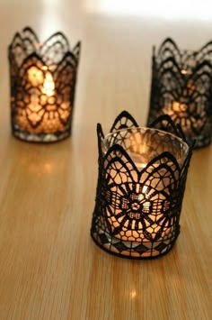 four small candles are sitting on a table