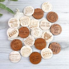 wooden buttons with words on them sitting next to a plant