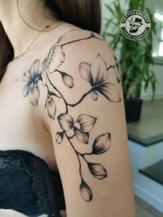 a woman's shoulder with flowers on it