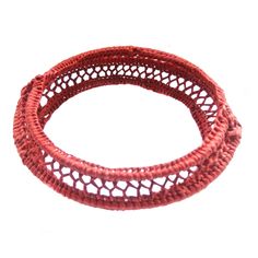 two red woven bracelets with holes on each side and an oval hole in the middle