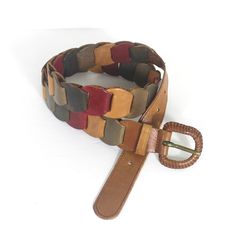 "Vintage Multicolour Leather Link Belt Faded Colours Red Tan Green Blue and a Woven leather buckle. This is a retro seventies style beautiful belt.   Genuine leather  Made in Thailand  33   39\" total length  Holes at 32\" 33\" 34\" 35\" 36\"  1 1/2\" wide   Find more vintage belts here: https://www.etsy.com/ca/shop/CuratedByLiane?ref=simple-shop-header-name&listing_id=1363727784&search_query=Belt Multiple items may be combined to save on shipping costs. Tags: Seventies  70's  Handmade  Retro  J Vintage Handmade Leather Belts, Retro Leather Belt Buckles, Handmade Vintage Leather Belt, Adjustable Retro Leather Belt Buckles, Retro Adjustable Leather Belt Buckles, Vintage Brown Leather Belt In Retro Style, 70s Belts, Retro Brown Belt Buckle With Antique Design, Retro Brown Belt Buckle With Belt Included