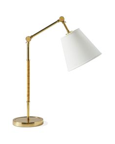 a lamp that is on top of a wooden base and has a white shade over it