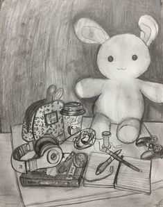 a drawing of a stuffed animal sitting on top of a table next to scissors and other items