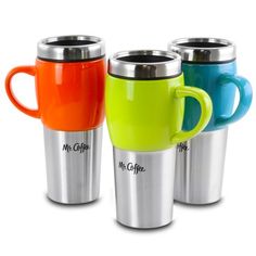 three different colored coffee mugs sitting next to each other