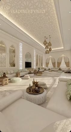 a large living room with white furniture and chandelier