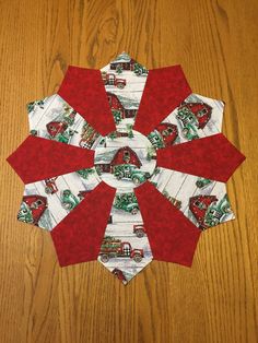 a red and white christmas ornament sitting on top of a wooden table