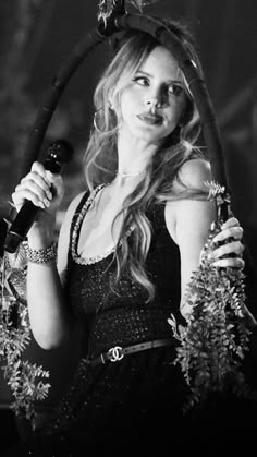 black and white photograph of a woman holding a microphone