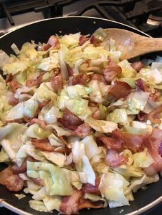 a frying pan filled with cabbage and bacon