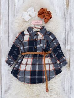 When you and your mom both need something autumnal and flannel-licious, reach for this cozy Mom & Me tunic and shirt set! The perfect plaid pairing, it's a match made in sartorial heaven. You'll look cozily chic all season long! Available in Navy, Sepia, & Orange. Kids sizes are true to size. We recommend 1-2 size up for a looser fit on mom sizes. 50% Polyester / 50% Cotton Accessories sold separately. Suggest bow color #1 or #44, #19 or #51. Import. **Afterpay and Sezzle Purchase Requires $35 M Woman Costumes, Holiday Fits, Cotton Accessories, Belted Tunic, Orange Kids, Navy Girl, Boy M, Girl M, Romper Outfit