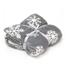 three blankets with snowflakes on them are folded up and tied to each other