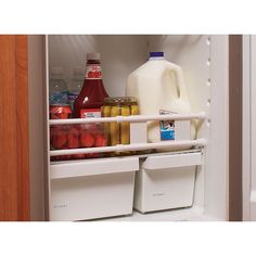 an open refrigerator with milk, yogurt and other drinks