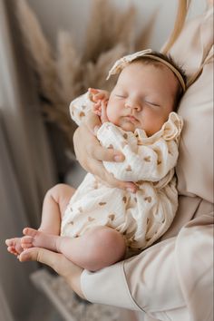 a woman holding a baby in her arms