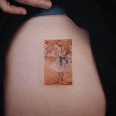 a woman's back with a painting on it that looks like she is wearing a dress