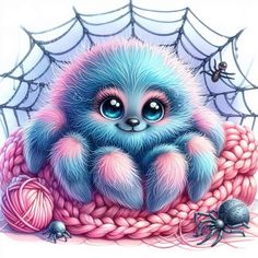 a blue and pink kitten sitting on top of a pile of yarn next to a spider