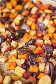 roasted vegetables on a baking sheet ready to be cooked