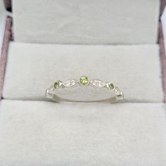 This Ring comes with a 100% Natural Green Peridot Gemstone and it is made up of 925 solid sterling silver. This ring is handcrafted by our skilled craftsmen and designed by us. Every gemstone is handpicked for the best quality.  Materials:- Silver (925 Solid Sterling Silver) Item Weight :- Approx. 1.50 Grams Gemstone:- Natural Green Peridot Stone Size :- 2.5MM Stone Shape :- Round Cut Secondary Stone : White Topaz ( 8 Stone) Select Size in Variation, if you don't find perfect size please buy any Silver Half Eternity Birthstone Ring Gift, Silver Half Eternity Birthstone Ring With Round Band, Stackable Peridot Rings For Anniversary, Stackable Peridot Birthstone Ring For Anniversary, Fine Jewelry Stackable Wedding Rings Stamped 925, Wedding Stackable Peridot Rings, Peridot Wedding Band, Peridot Engagement Rings, Wedding Band Women