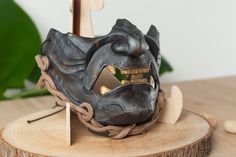 a mask is sitting on top of a piece of wood