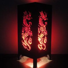 a lit up box with two red dragon designs on it's front and back sides